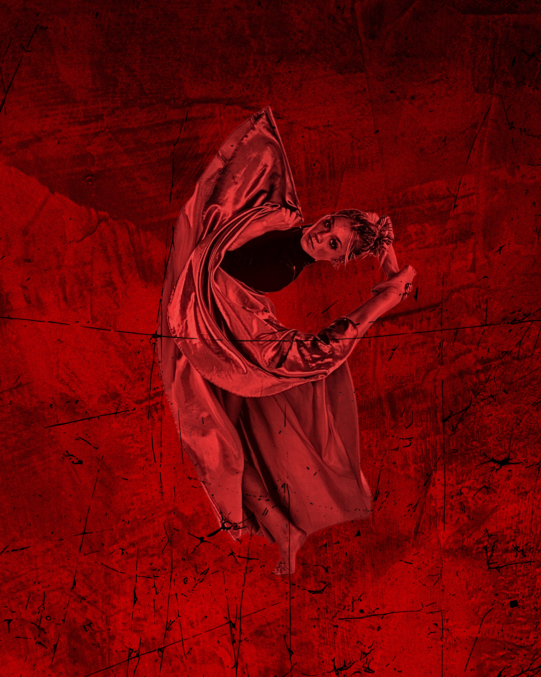 Female dancer posed wearing flowing satin costume with red lighting and red background